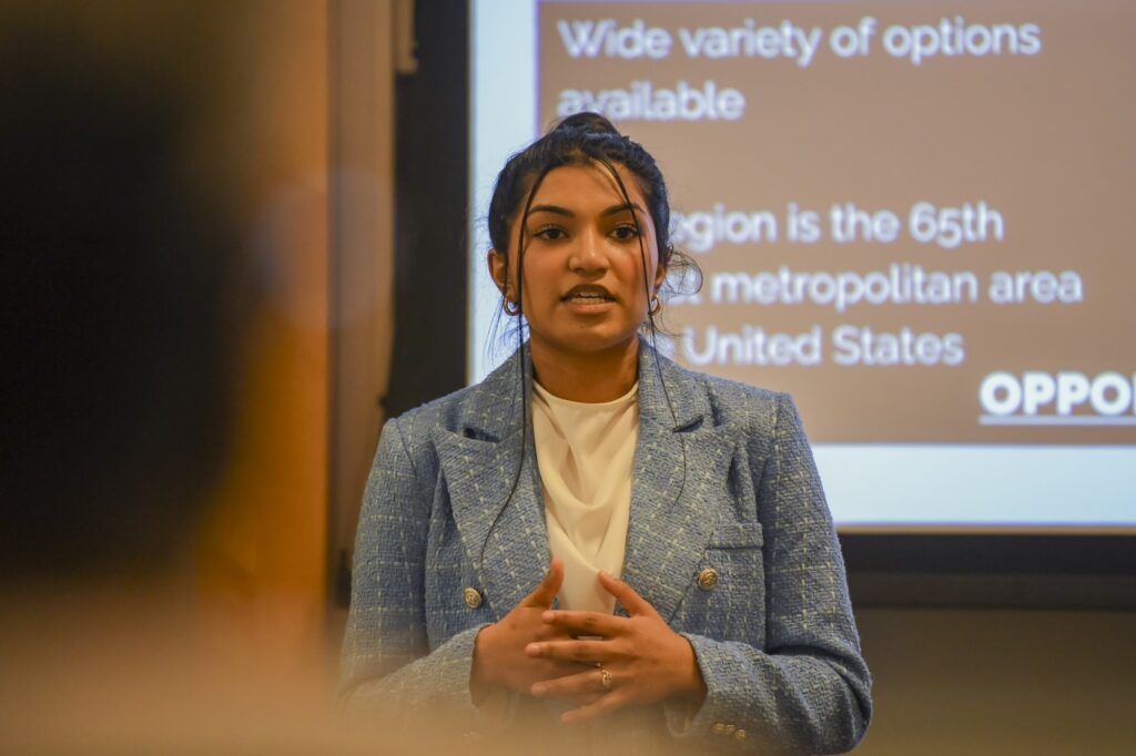 Student wearing blazer jacket presenting at Impact Competition
